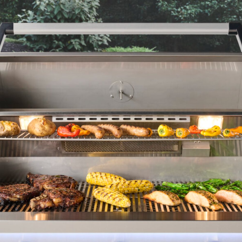 Open built-in gas grill with lit burners and grilled corn, meat, and peppers