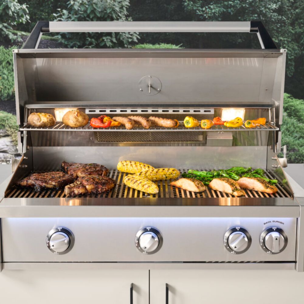 Stainless steel gas grill with open hood showing lit burners and cooking grate