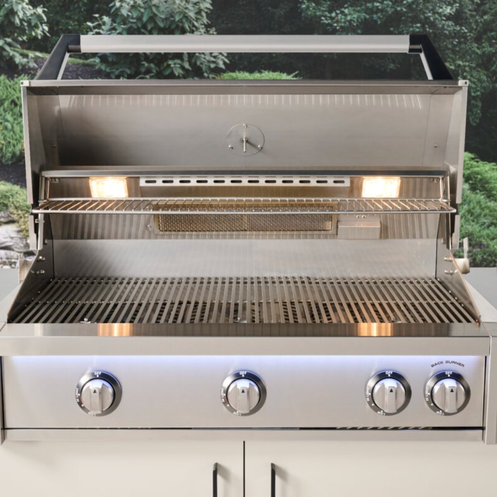 Stainless steel gas grill with open hood, active flames, and empty lower warming grates