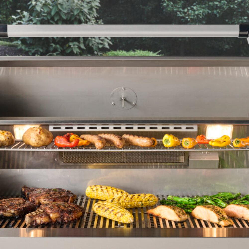 Built-in gas grill interior with grilled chicken, peppers, and corn on warming rack