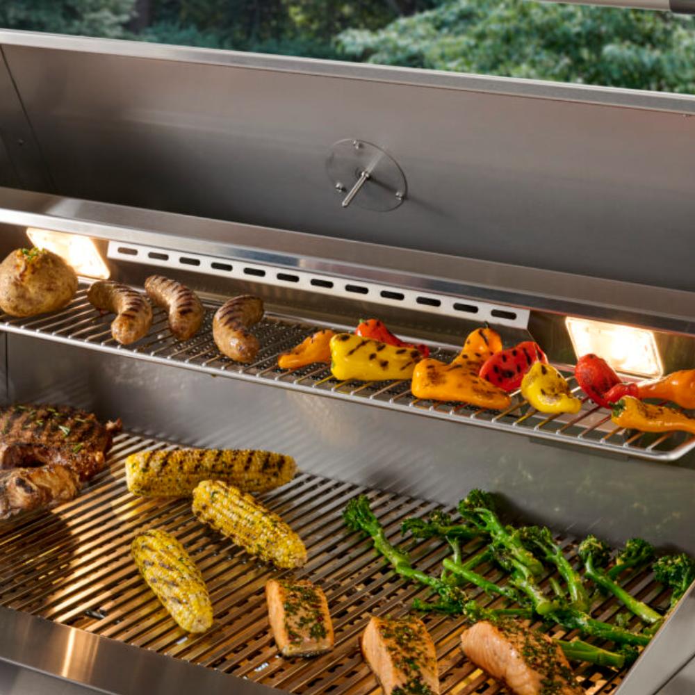 Open built-in gas grill with burgers, peppers, and corn on the grates