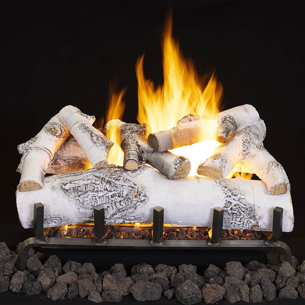 Ceramic fiber gas log set with glowing flames and white birch logs on ember bed