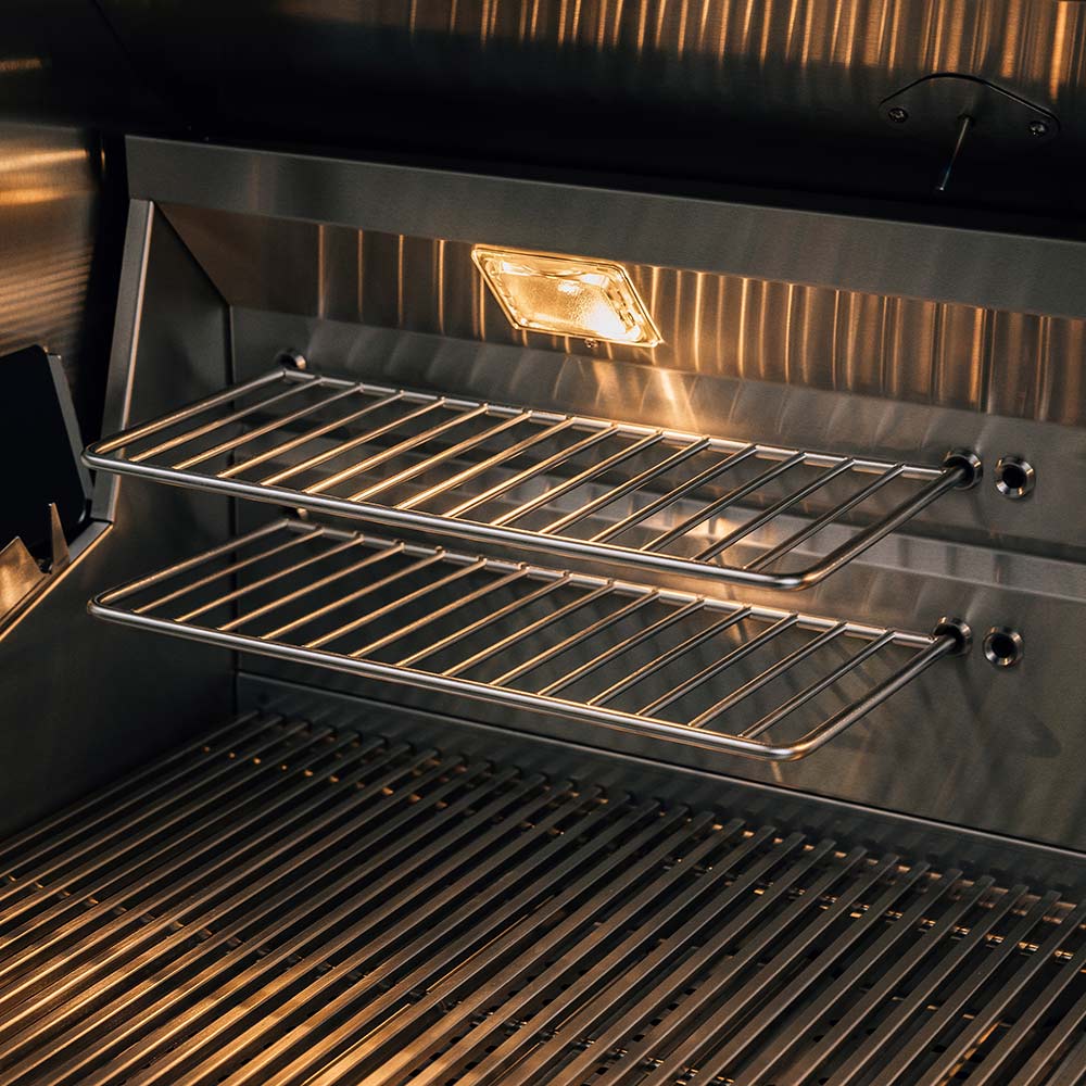 Stainless gas grill cooking grates with lit burners and a radiant heat section