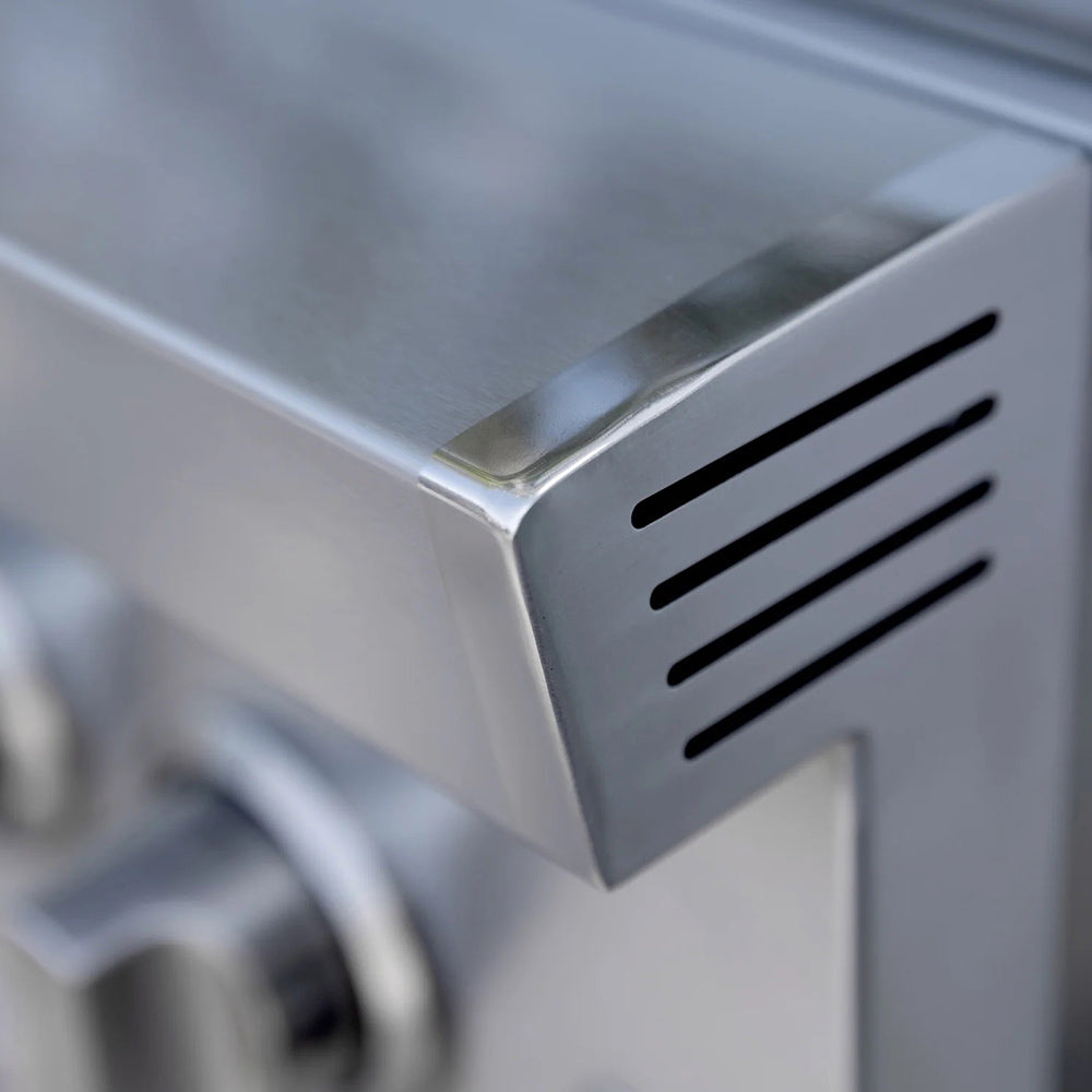 Stainless steel vent grille on built-in double side burner grill housing.