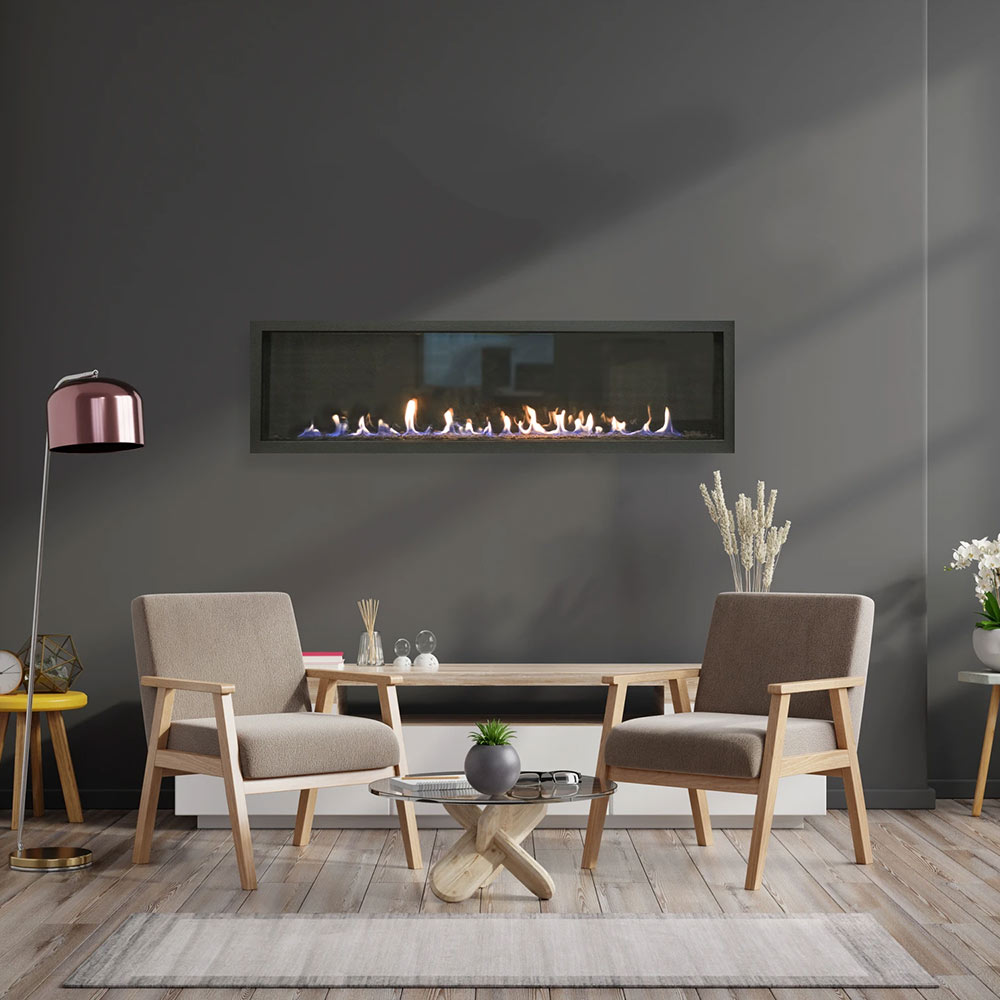 Linear gas fireplace with flames behind a dark frame, set above a console table.