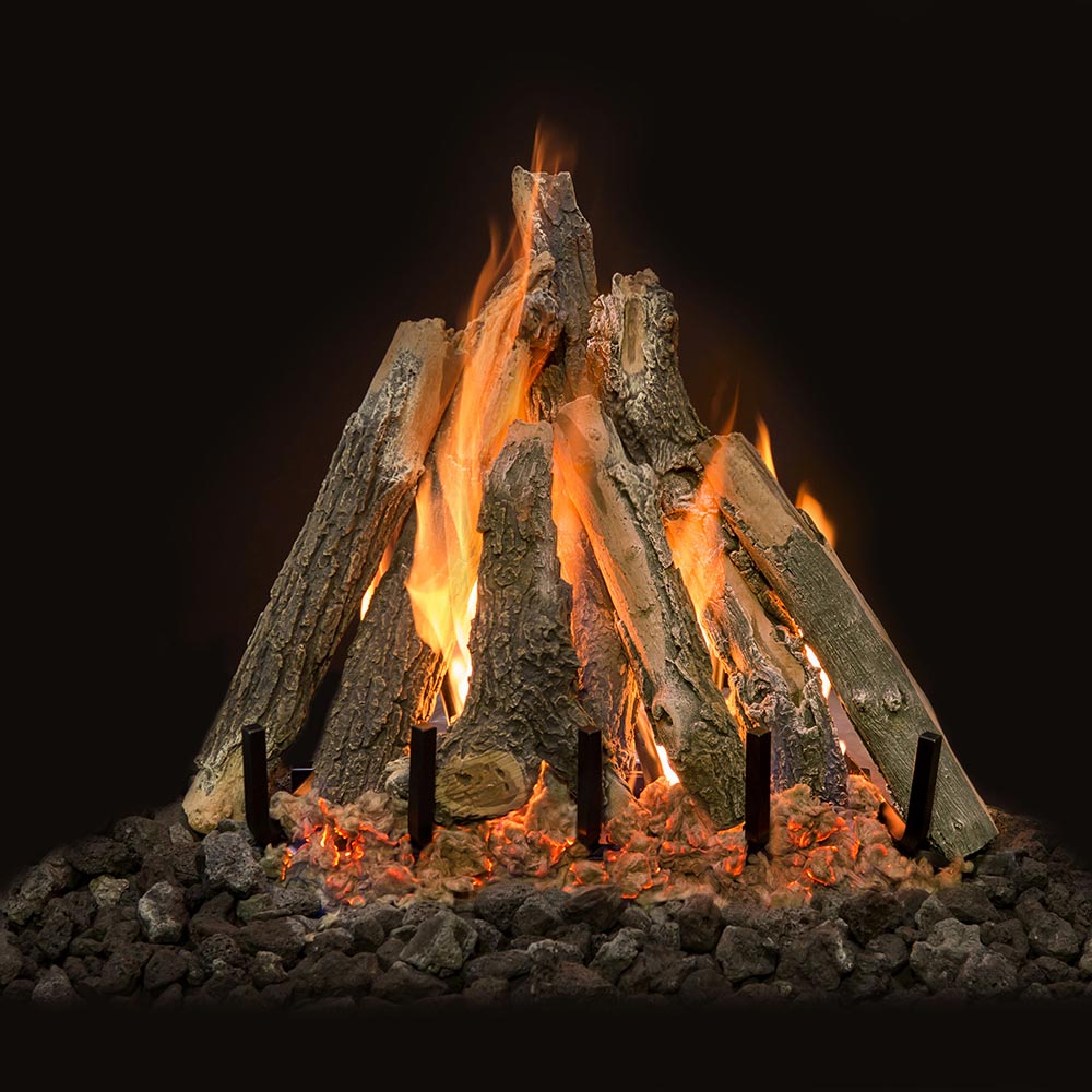 Gas log set with stacked weathered wood logs and flames, set in black grate