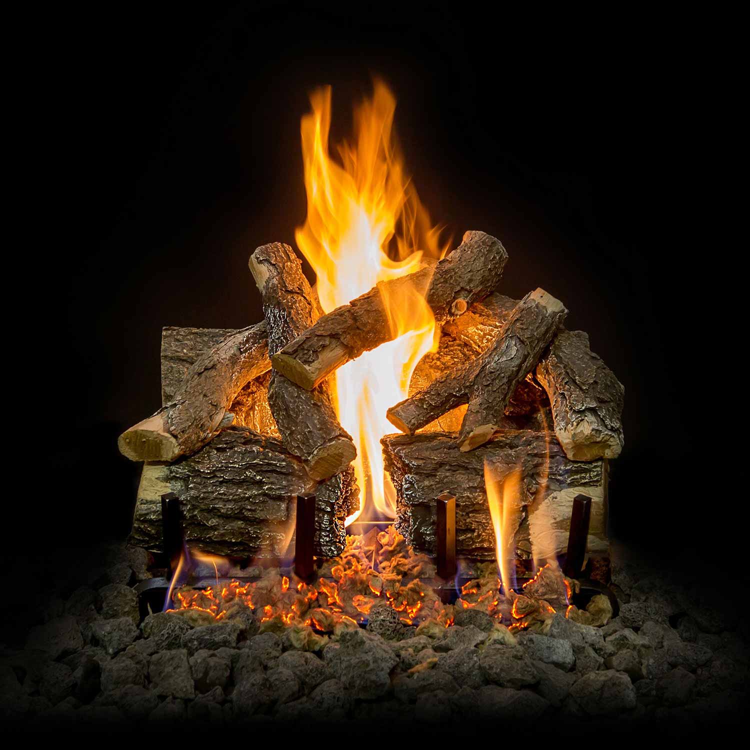Charred oak gas log set with tall flames rising from an ember bed