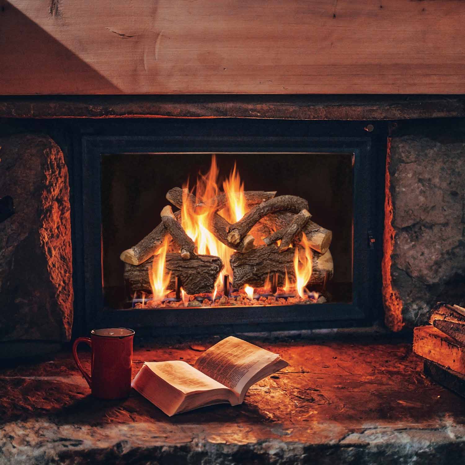 Charred wood gas log set with flames inside a fireplace opening, vented burner-style logs