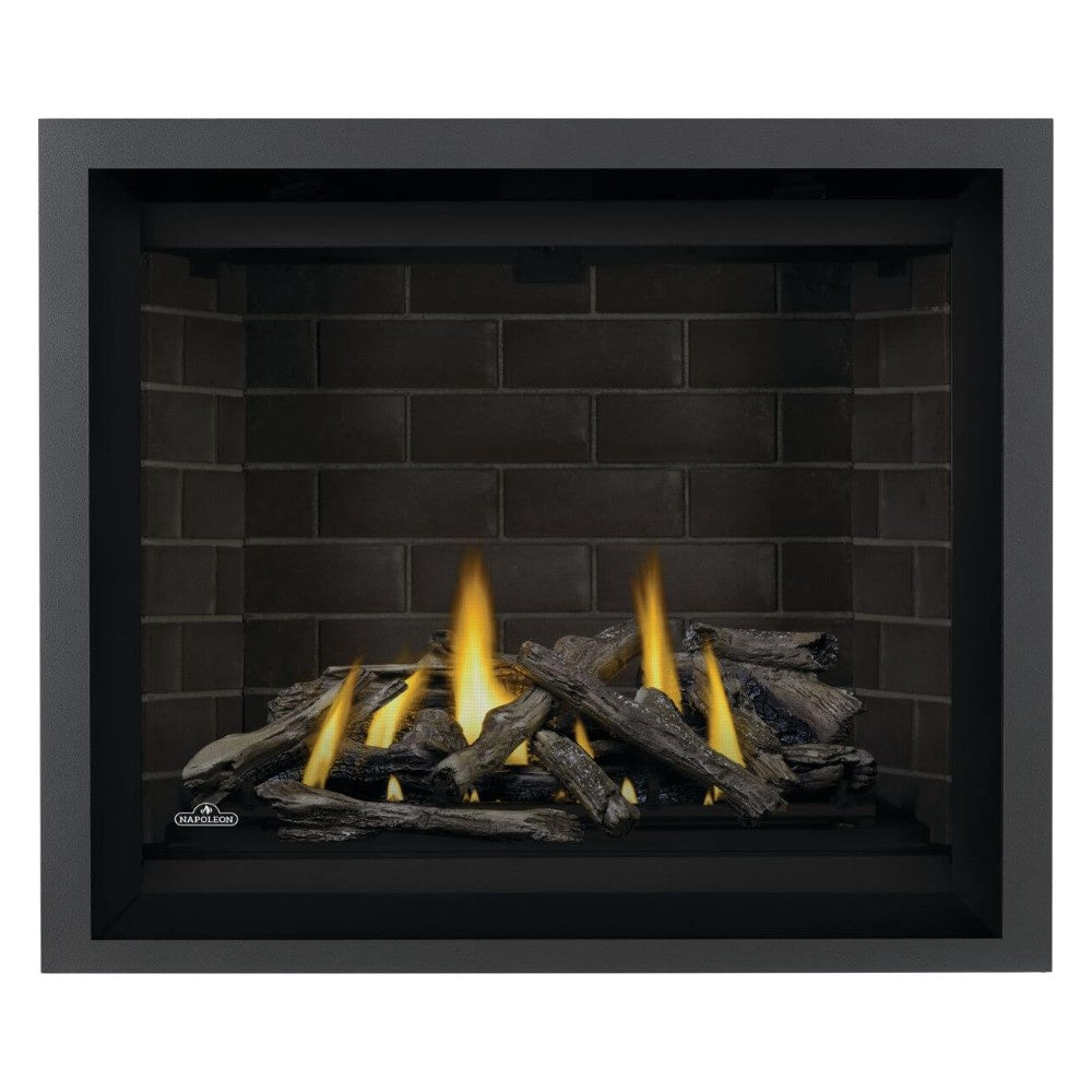 Direct vent gas fireplace with black surround and glowing yellow flames over dark logs
