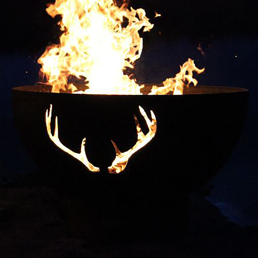 Dark steel fire pit with antler cutouts and bright flames above the bowl