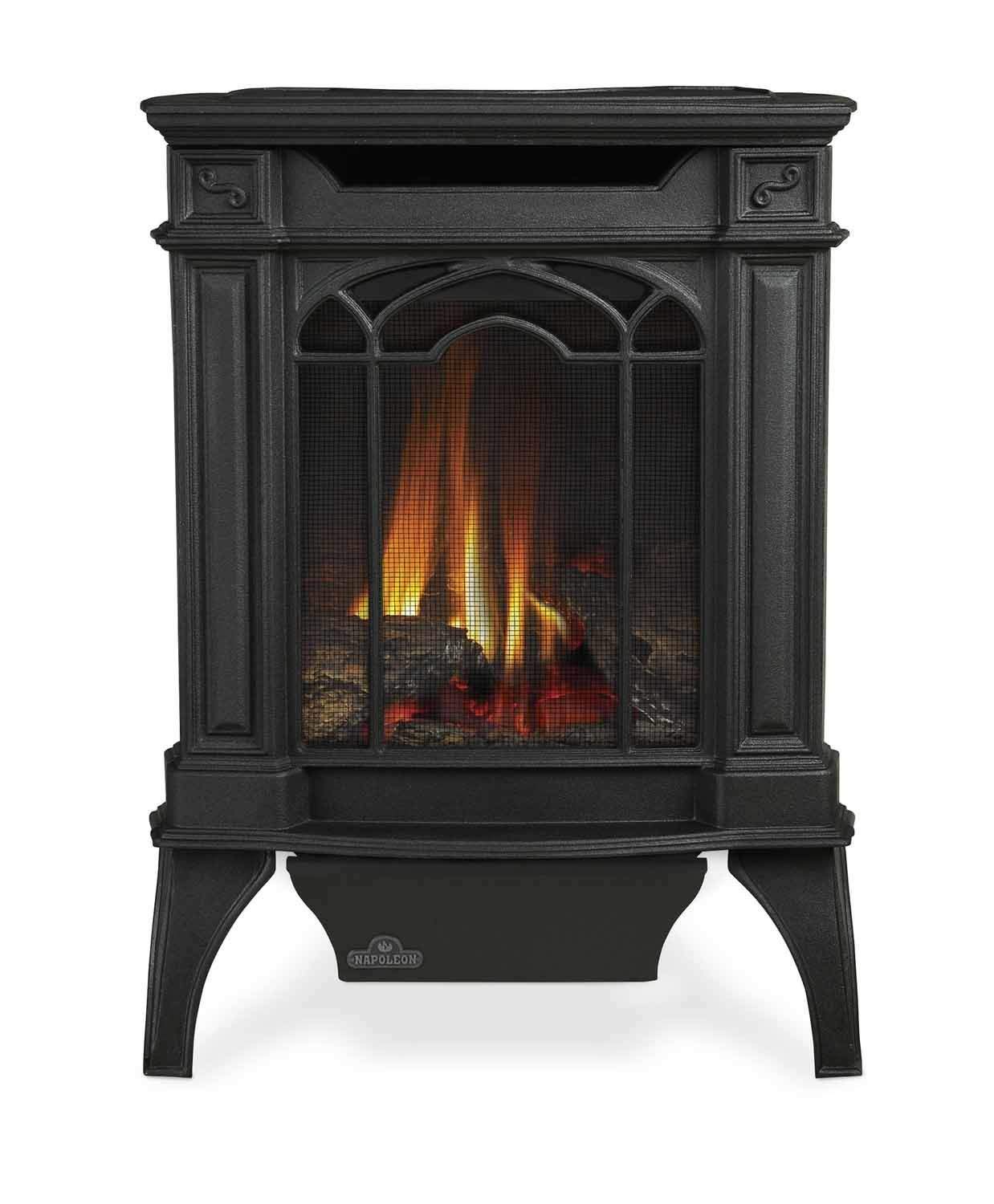 Black cast iron direct vent stove with glass front and glowing flames, electronic ignition