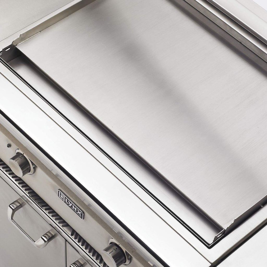 Open stainless grill lid showing cooking grates and burners