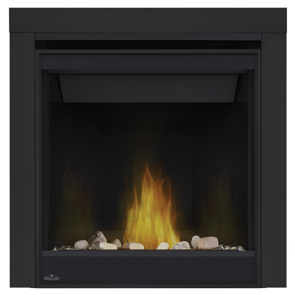 Direct vent gas fireplace with black surround, glass front, and glowing flame over stones