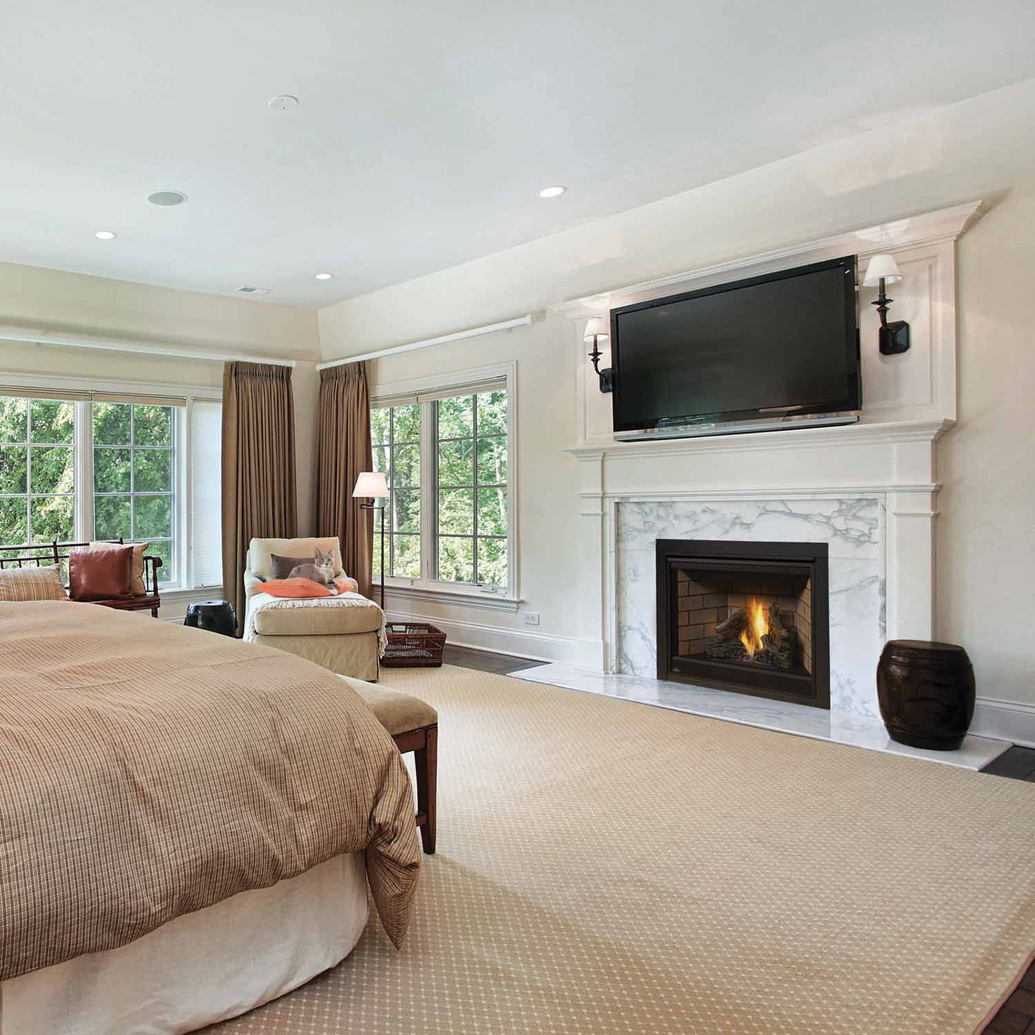 Direct vent gas fireplace with black firebox insert and glass opening, burning logs in a white mantel
