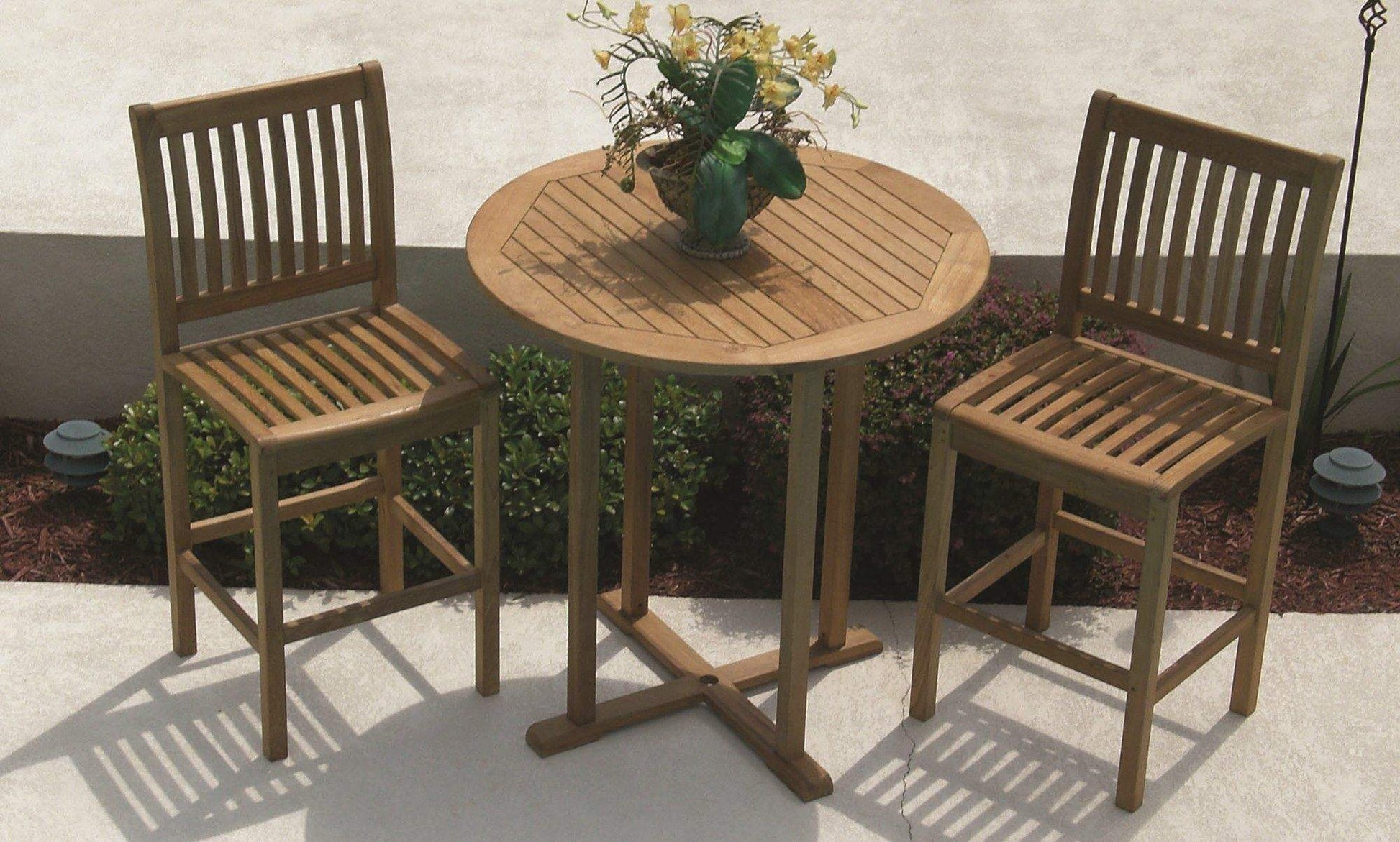 Teak bar chairs with slatted backs and seats, shown with a round patio table