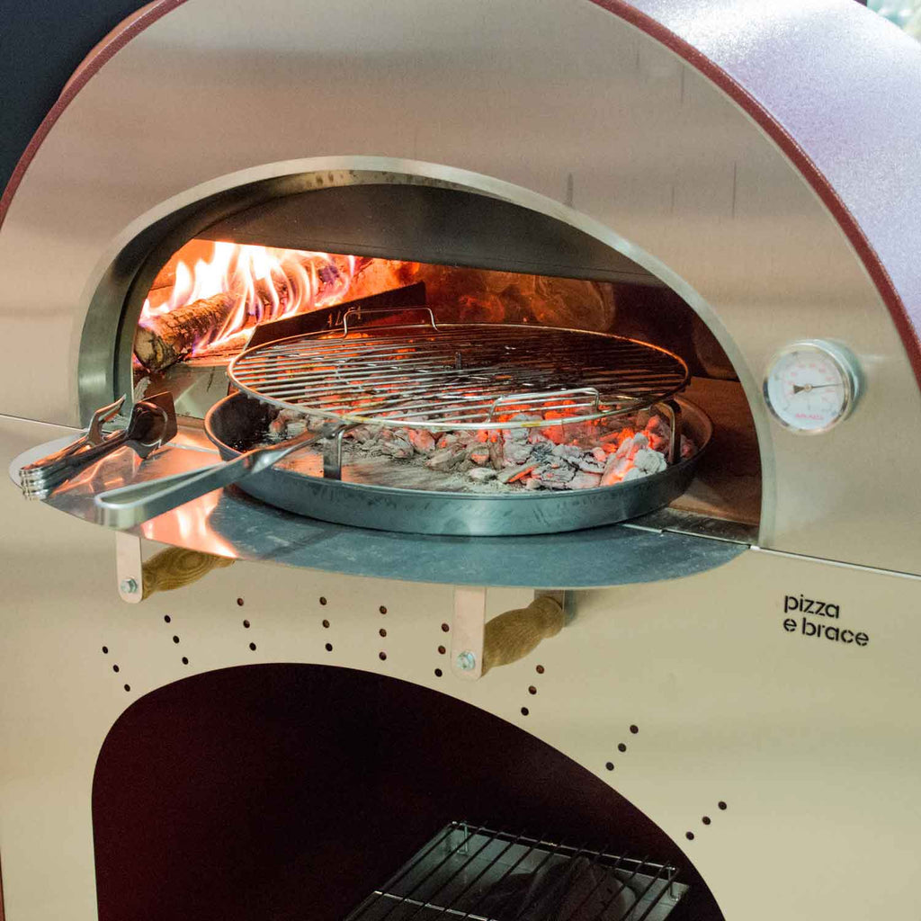 Wire grilling grate inside an open grill chamber