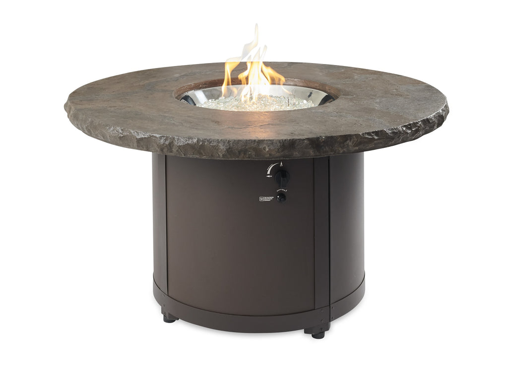 Round fire pit table with dark stone-look top and black base, flame in center
