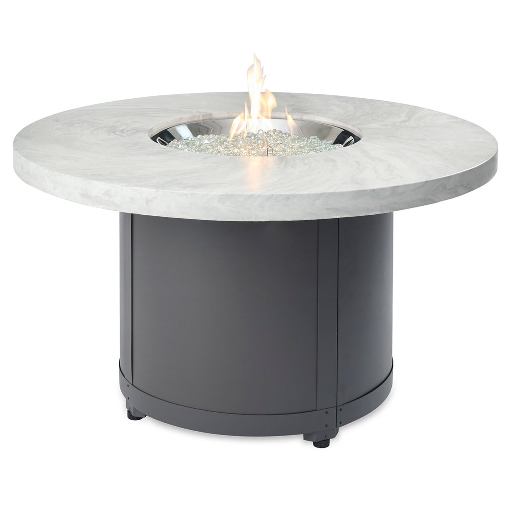 Round fire pit table with light marble top and dark charcoal base, flame in center