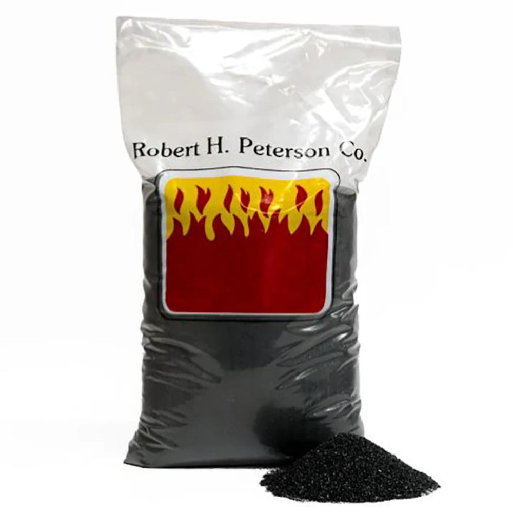 Black sand in resealable bag with flame logo label, with a small pile of sand