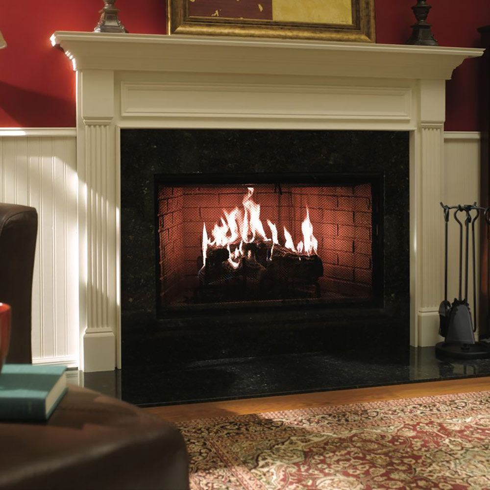 Wood burning fireplace with white mantel and black surround, burning flames in brick interior