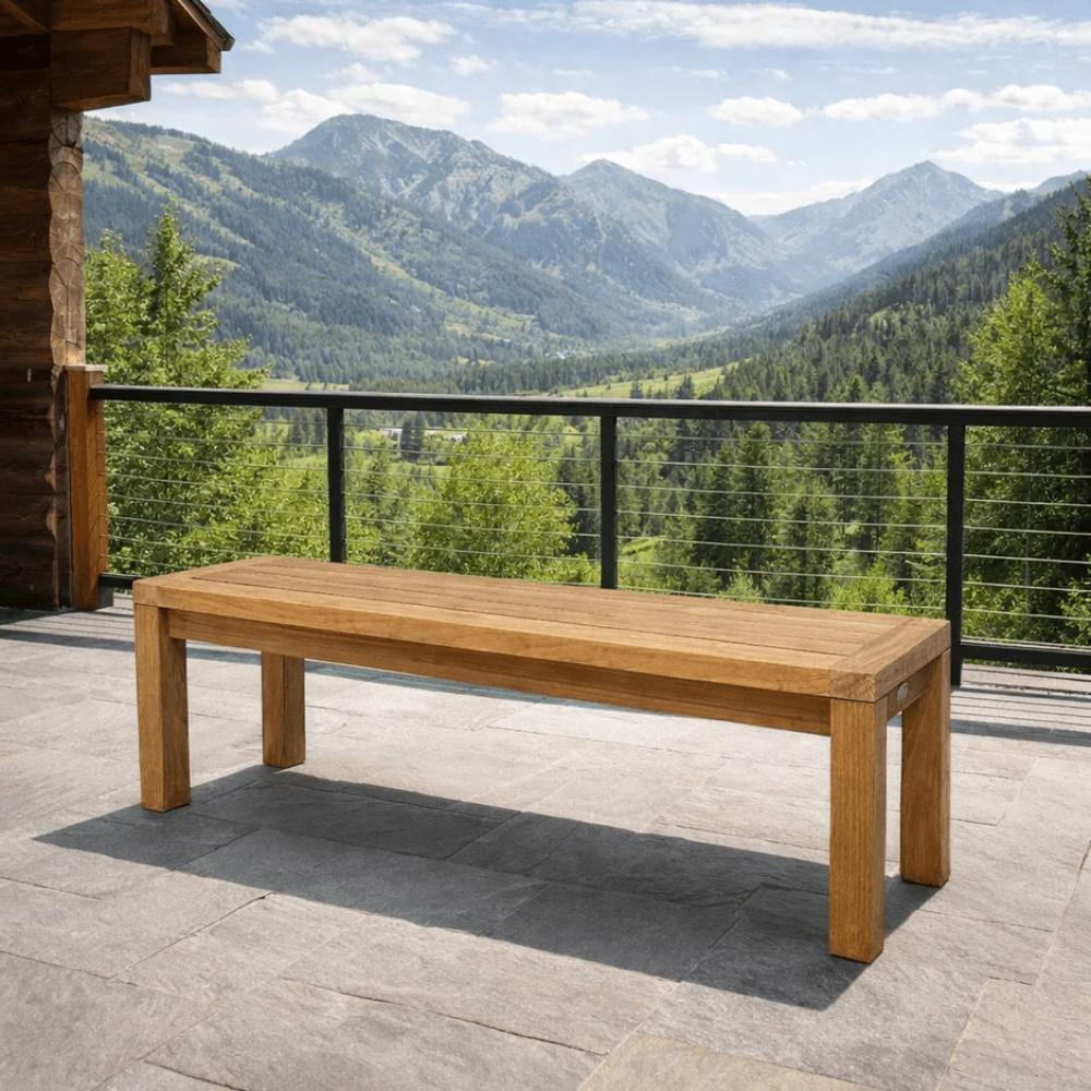 Solid teak dining bench with slatted tabletop and tapered legs for outdoor dining.
