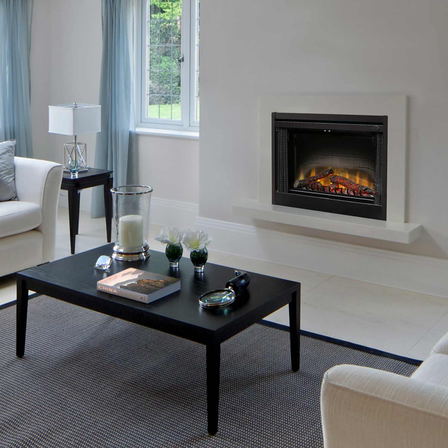 Electric fireplace insert in wall opening with black frame and flame log display