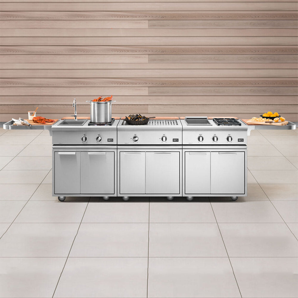 Outdoor built-in stainless steel grill with multiple burners and griddle on storage base