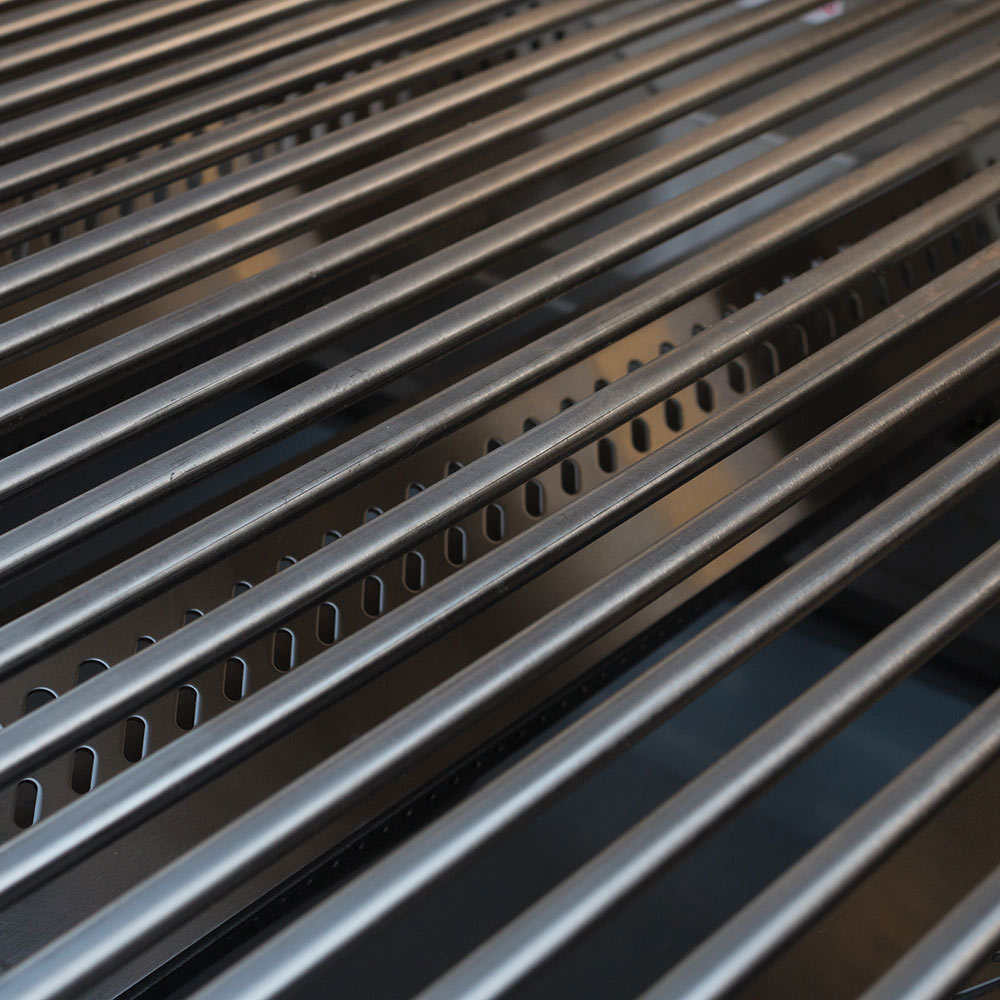Metal grill grates with evenly spaced slots for searing and cooking