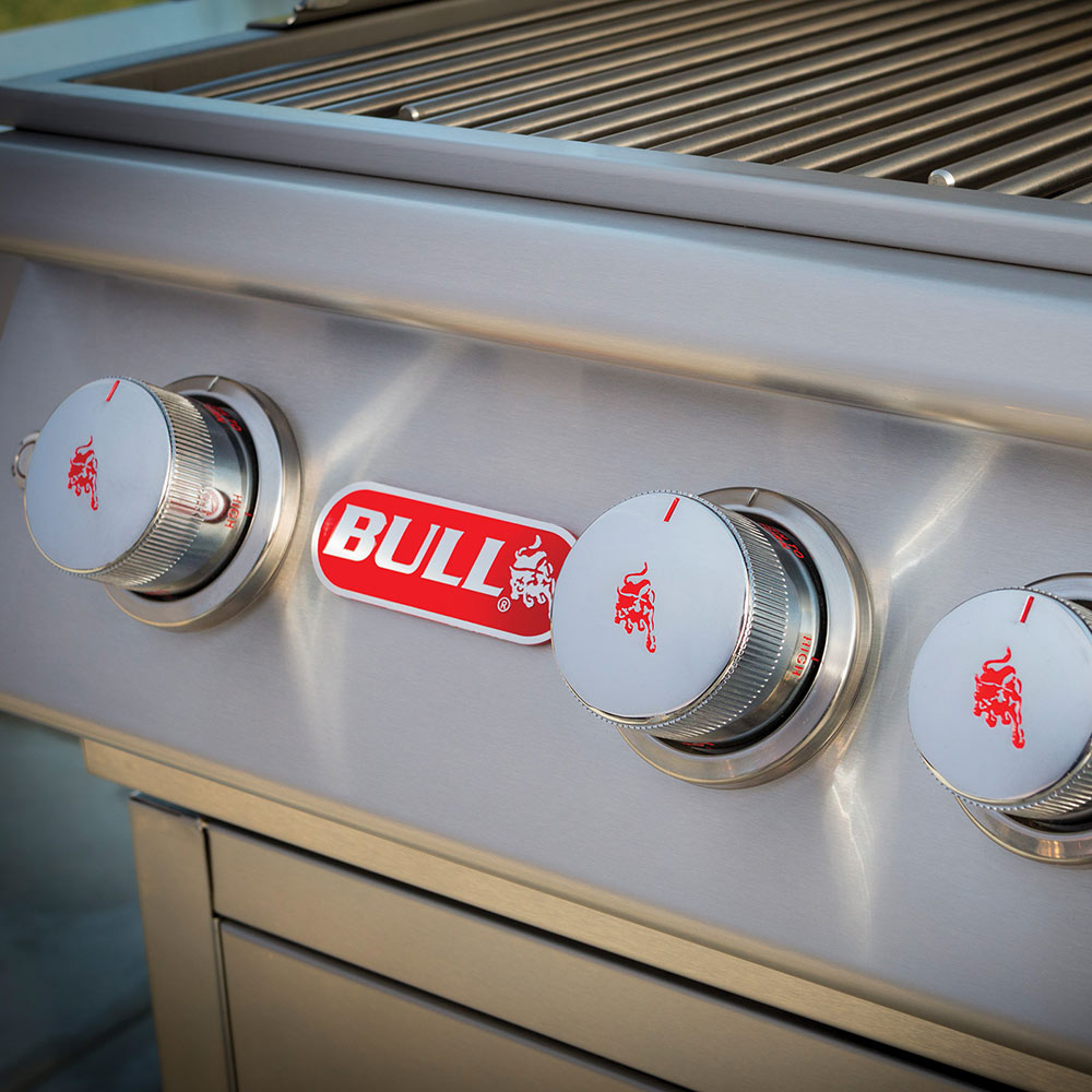 BULL grill front control knobs with metallic caps on a stainless steel panel