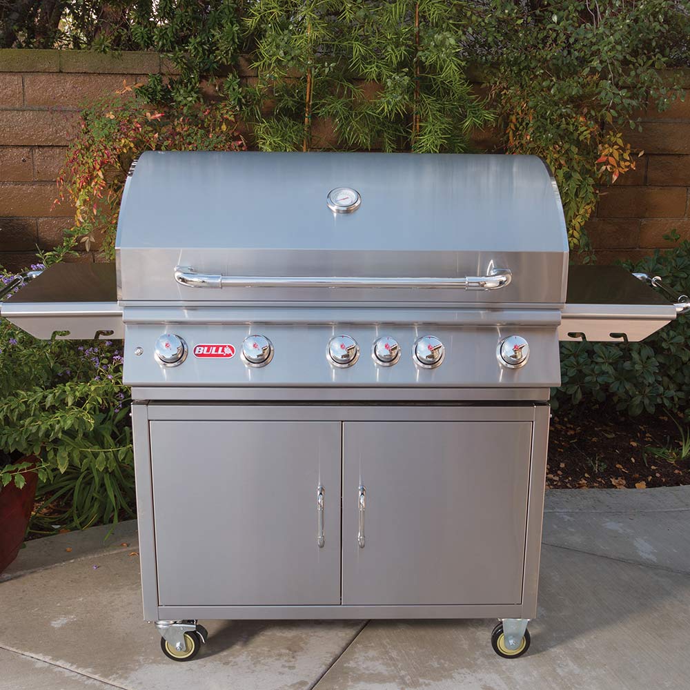 Stainless steel gas grill on cart outdoors with BULL logo on control panel