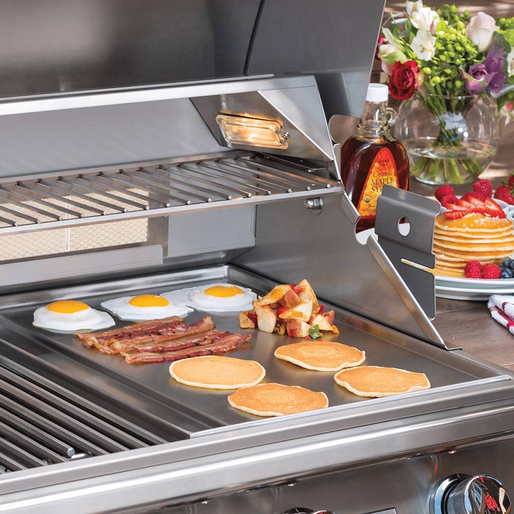 Stainless steel pro grill griddle surface with pancakes, bacon, and eggs