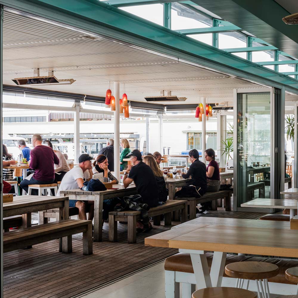 Infrared patio electric heaters with glowing red elements under restaurant canopy