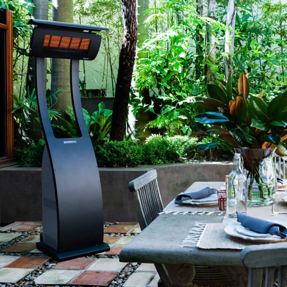 Tungsten portable radiant heater with black body and glowing burner grille outdoors