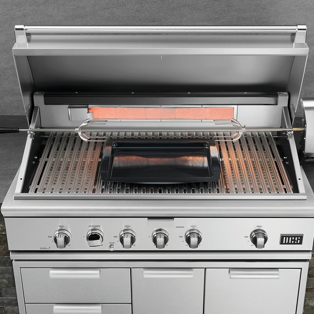Built-in gas grill with open lid, stainless burners, and cooking grates inside
