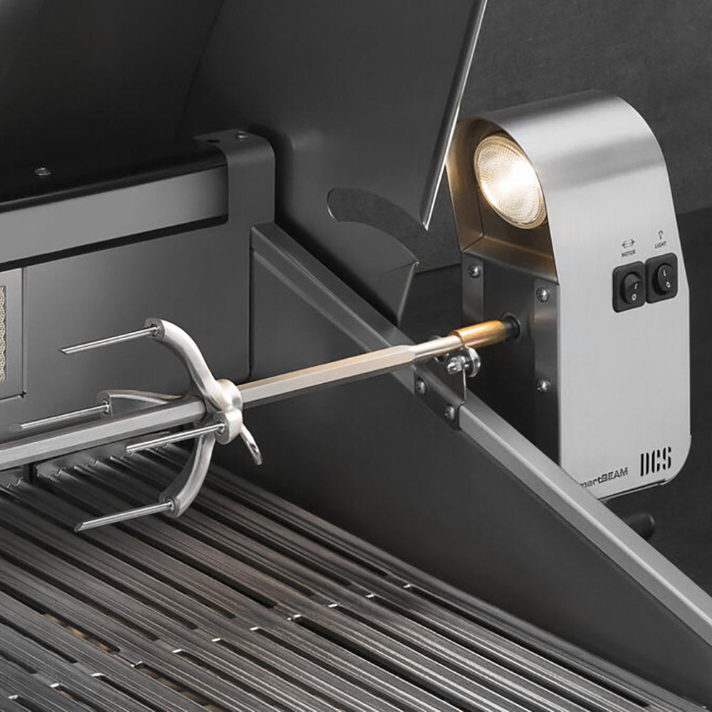 Stainless steel rotisserie spit inside open grill hood with rear burner