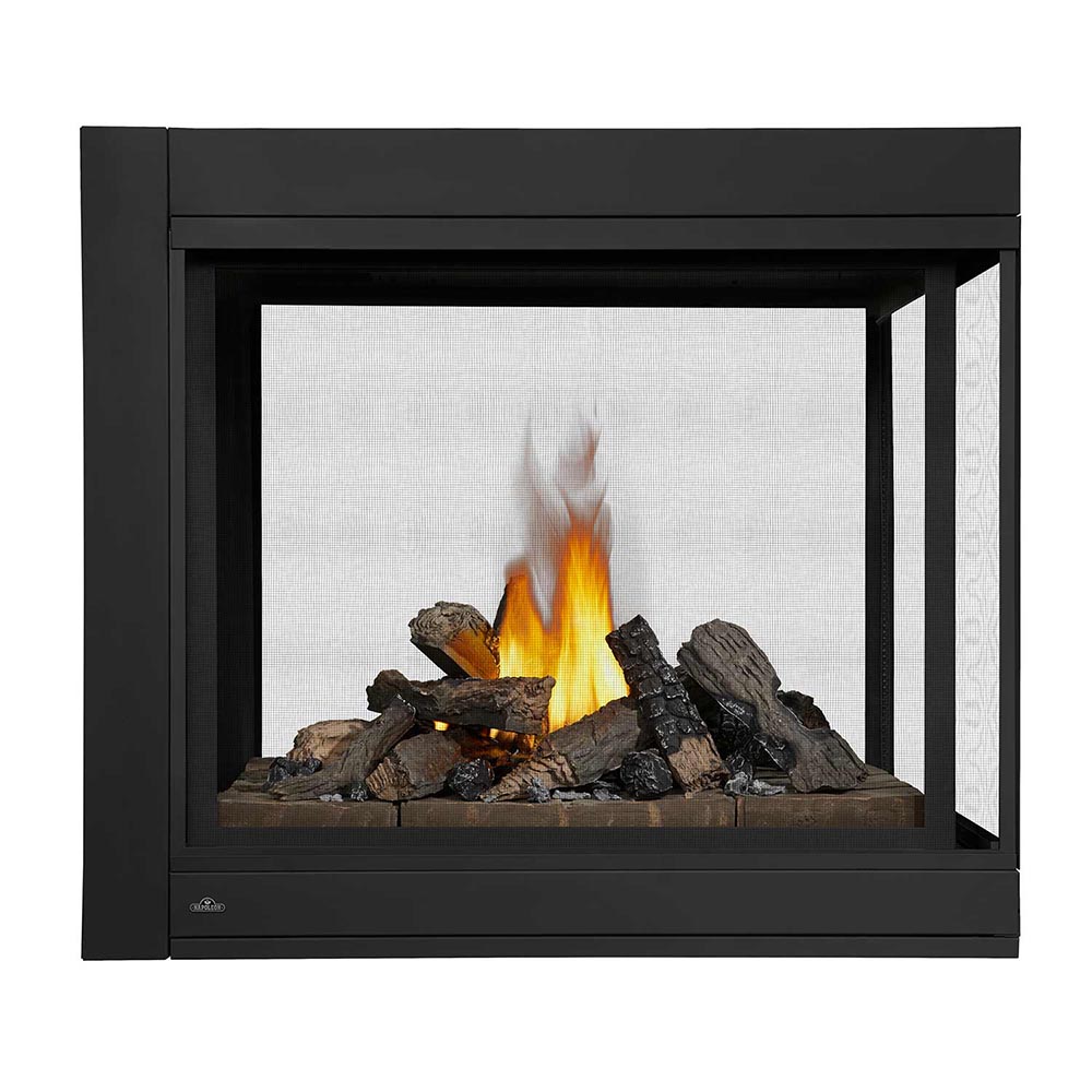 Black gas fireplace insert with stone media and bright orange flames behind glass