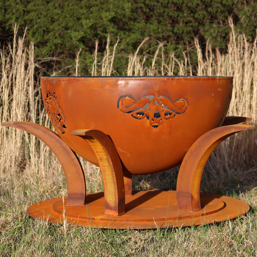 Wood fire pit with orange steel bowl, animal cutout, and curved metal legs.