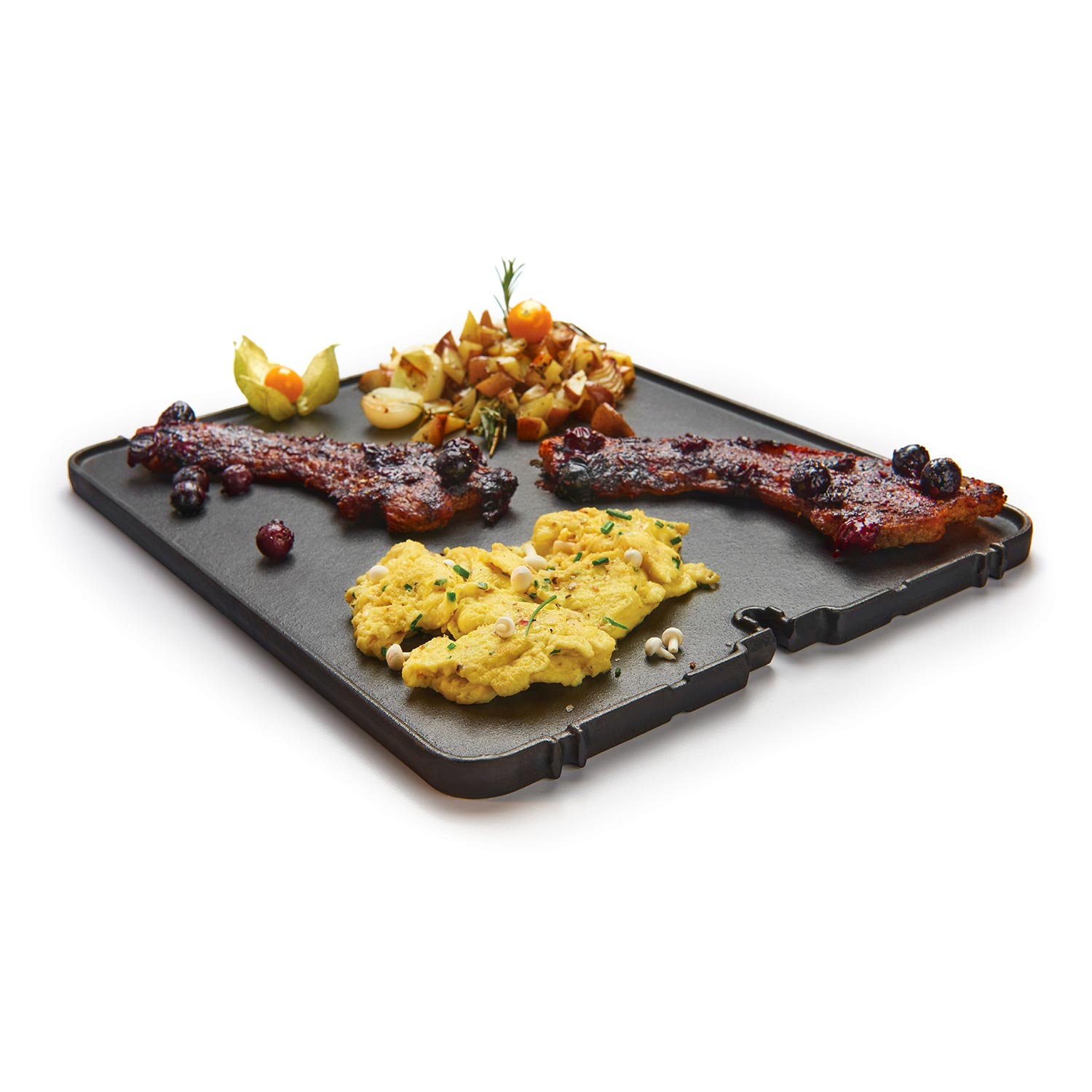Cast iron griddle with raised ridges, showing cooked food on top