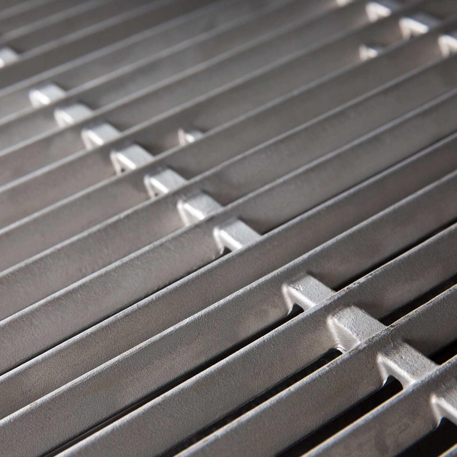 Close-up of stainless steel cooking grid bars and notch cutouts