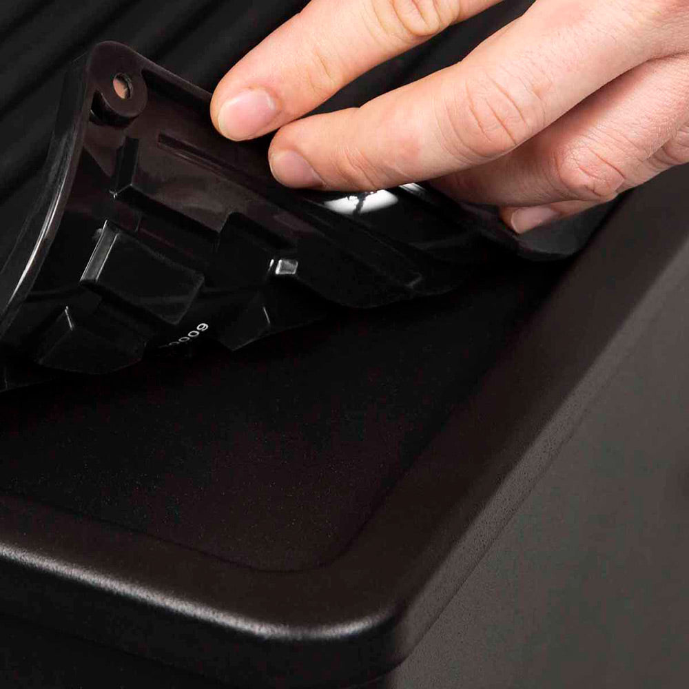 Black silicone mat corner with locking tabs and molded grip openings