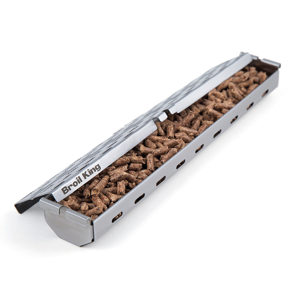 Broil King stainless steel pellet smoker box filled with brown pellets, perforated top