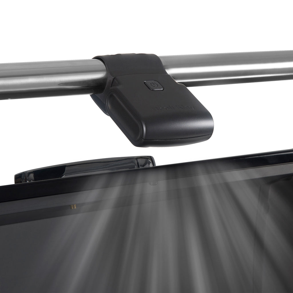 Broil King grill light on grill frame casting a beam downward