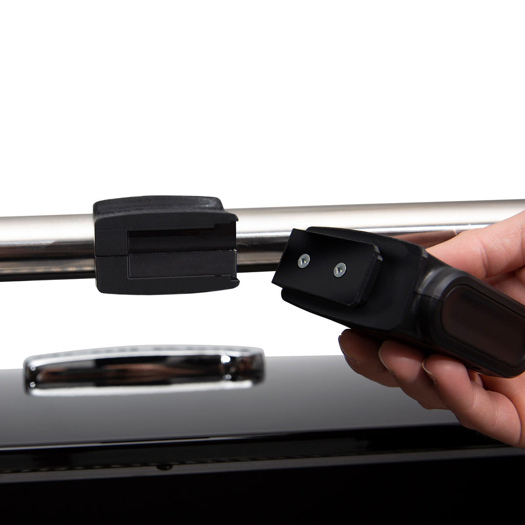 Black handle-mounted grill light being attached to the grill handle