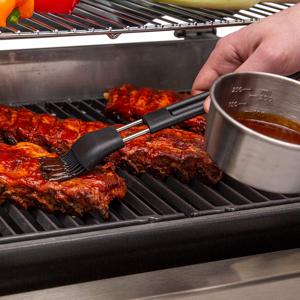 Black basting brush with sauce cup, basting grilled meat on grates