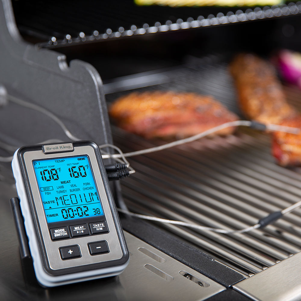Digital meat thermometer controller on grill rack with two connected temperature probes