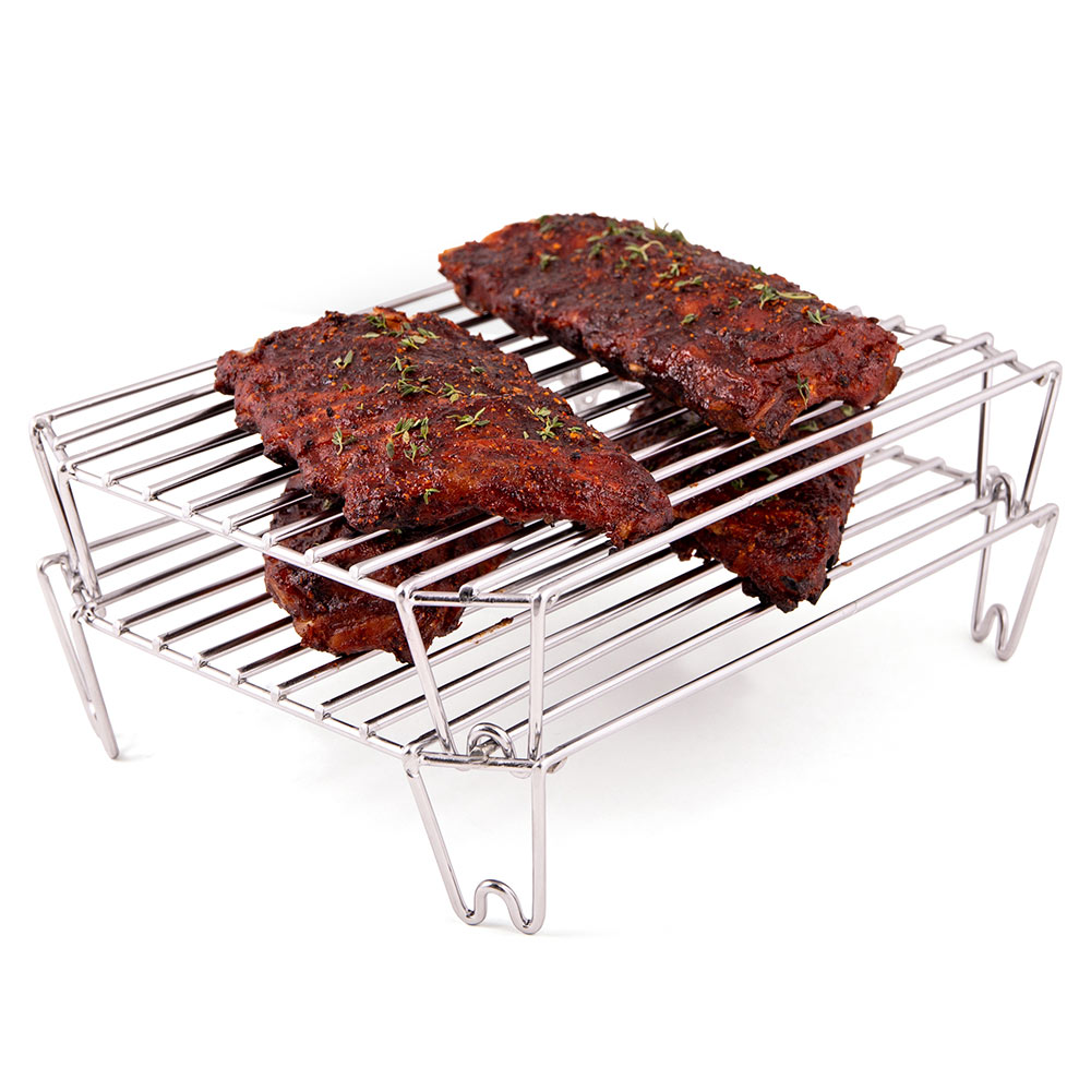 Stainless steel rack with two stacked slabs of seasoned meat on wire grates