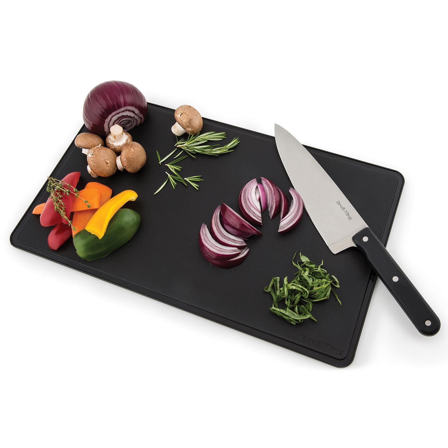 Black cutting board with chef knife and assorted vegetables for grilling prep