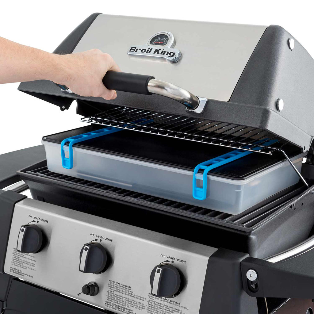 Broil King grill with black griddle insert and blue frame handles