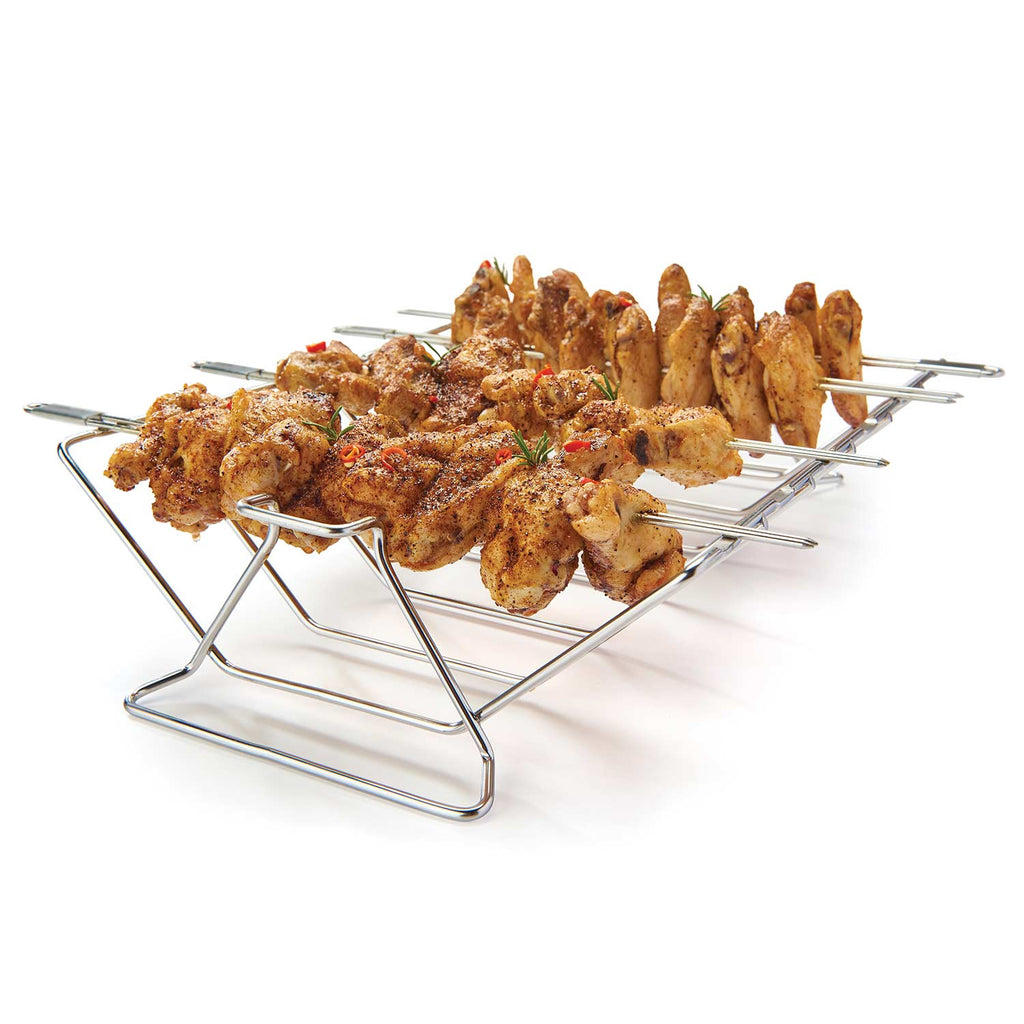 Stainless steel multi-rack skewer kit with wire supports and skewers holding cooked meat