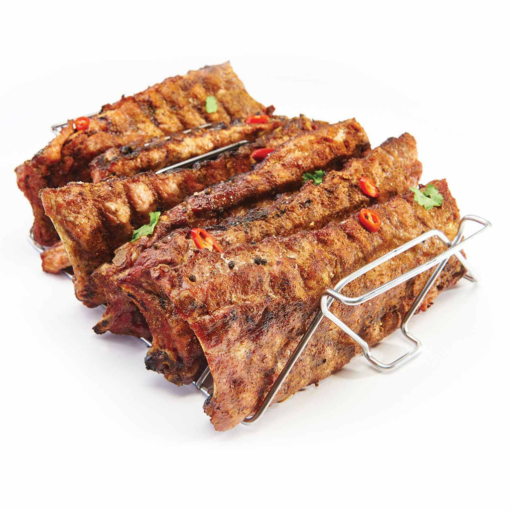 Stainless steel skewer rack with several skewers on a wire frame holding grilled meat